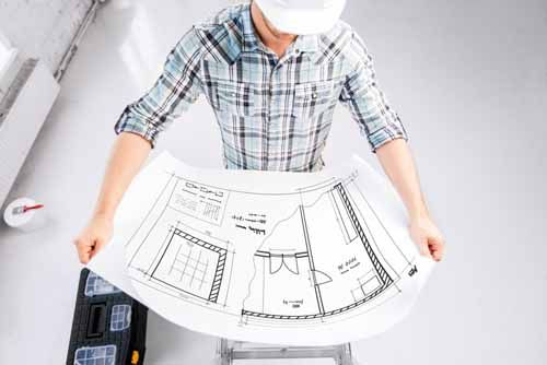 A contractor looks over blueprints